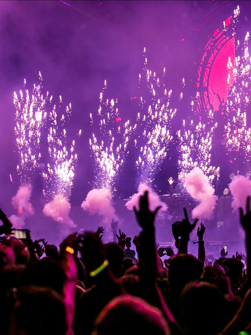 Pyrotechnics above a crowd at a live concert